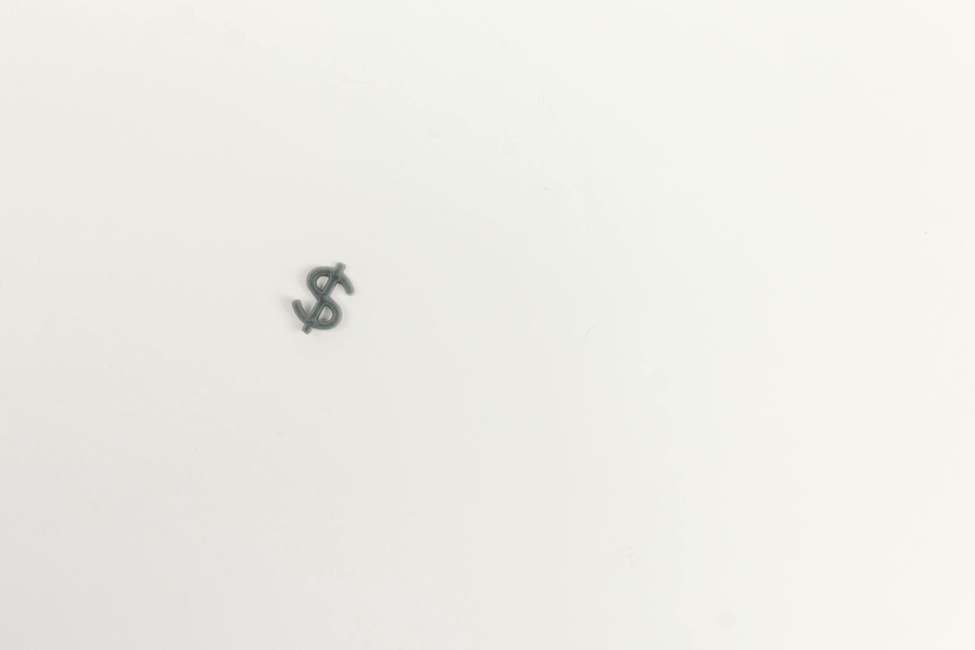 A small black dollar sign on a plain white background.