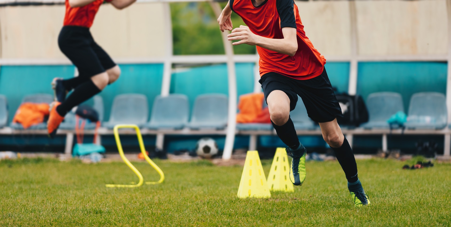 Boy Soccer Player In Training. Boys Running Between Cones amd Jumping During Practice in Field on Sunny Day. Young Soccer Players at Speed and Agility Practice Session